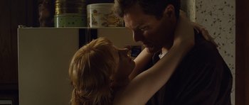 Movie still from “Take Shelter” (2011), directed by Jeff Nichols – A man and a woman embracing each other in a room; Close Up shot, Low angle