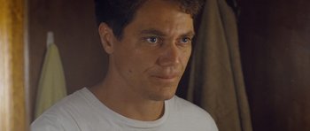 Movie still from “Take Shelter” (2011), directed by Jeff Nichols – A person wearing a white t - shirt; Close Up shot, Low angle