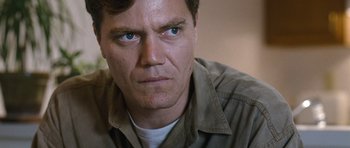 Movie still from “Take Shelter” (2011), directed by Jeff Nichols – A man's face with a serious look; Close Up shot, Low angle
