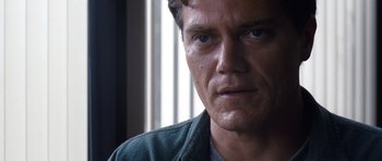 Movie still from “Take Shelter” (2011), directed by Jeff Nichols – A man's face in front of a window; Close Up shot, Over the shoulder angle