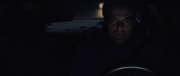Movie still from “Take Shelter” (2011), directed by Jeff Nichols – A man sitting in the driver's seat of a car at night; Close Up shot, Over the shoulder angle