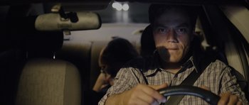 Movie still from “Take Shelter” (2011), directed by Jeff Nichols – A man driving in a car while a woman sits in the passenger seat; Close Up shot, Over the shoulder angle