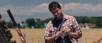 Movie still from “Take Shelter” (2011), directed by Jeff Nichols – A man standing in the middle of an open field; Close Up shot, Over the shoulder angle