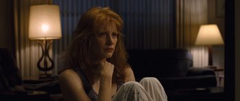 Movie still from “Take Shelter” (2011), directed by Jeff Nichols – A woman sitting on the ground with her hand on her chin; Close Up shot, Low angle