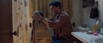 Movie still from “Take Shelter” (2011), directed by Jeff Nichols – A man holding a towel over his shoulder; Medium shot, High angle