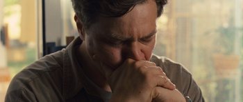 Movie still from “Take Shelter” (2011), directed by Jeff Nichols – A person holding his hands to his face; Close Up shot, Low angle