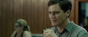 Movie still from “Take Shelter” (2011), directed by Jeff Nichols – A person holding a cigarette; Close Up shot, Over the shoulder angle