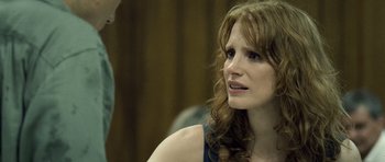 Movie still from “Take Shelter” (2011), directed by Jeff Nichols – A person sitting in a room; Close Up shot, Over the shoulder angle