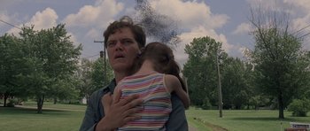 Movie still from “Take Shelter” (2011), directed by Jeff Nichols – A man holding a little girl in his arms; Close Up shot, Low angle
