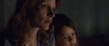 Movie still from “Take Shelter” (2011), directed by Jeff Nichols – A woman and a young girl looking at the camera; Close Up shot, Low angle