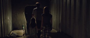 Movie still from “Take Shelter” (2011), directed by Jeff Nichols – A group of people standing next to each other in the dark; Wide shot, Low angle