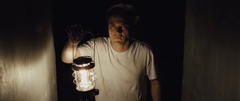 Movie still from “Take Shelter” (2011), directed by Jeff Nichols – A man is holding a lantern in the dark; Close Up shot, Low angle
