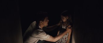 Movie still from “Take Shelter” (2011), directed by Jeff Nichols – A man and a little girl standing next to each other in the dark; Medium shot, Over the shoulder angle