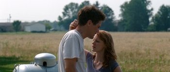 Movie still from “Take Shelter” (2011), directed by Jeff Nichols – A man and a woman kissing in a grassy field; Close Up shot, Low angle