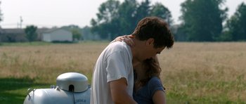 Movie still from “Take Shelter” (2011), directed by Jeff Nichols – A man and a woman hugging in a field; Medium shot, Over the shoulder angle