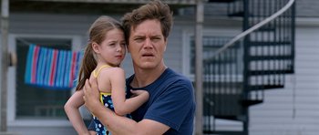 Movie still from “Take Shelter” (2011), directed by Jeff Nichols – A man holding a little girl in his arms; Close Up shot, Low angle