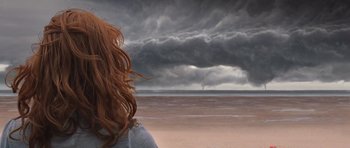 Movie still from “Take Shelter” (2011), directed by Jeff Nichols – A woman standing on the beach looking out at a storm; Medium shot, Low angle