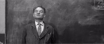 Movie still from “The 400 Blows” (1959), directed by François Truffaut – An old photo of a man wearing a suit and tie; Close Up shot, Low angle