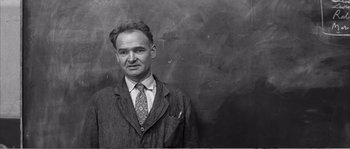 Movie still from “The 400 Blows” (1959), directed by François Truffaut – An old photo of a man wearing a suit and tie; Medium shot, Low angle