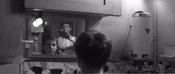 Movie still from “The 400 Blows” (1959), directed by François Truffaut – A boy looking in a mirror at a man brushing his teeth; Close Up shot, Over the shoulder angle