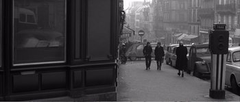 Movie still from “The 400 Blows” (1959), directed by François Truffaut – Two men walking down a street in a city; Wide shot, High angle