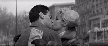 Movie still from “The 400 Blows” (1959), directed by François Truffaut – A man and a woman kissing each other in a black and white photo; Close Up shot, Low angle