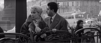 Movie still from “The 400 Blows” (1959), directed by François Truffaut – A man and a woman are sitting on a bench; Medium shot, Low angle