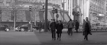 Movie still from “The 400 Blows” (1959), directed by François Truffaut – A couple of people that are walking down the street; Wide shot, High angle