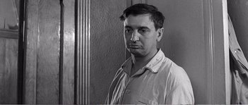 Movie still from “The 400 Blows” (1959), directed by François Truffaut – Black and white photograph of a man in pajamas; Close Up shot, Low angle