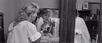 Movie still from “The 400 Blows” (1959), directed by François Truffaut – A black and white photo of a woman looking in the mirror; Close Up shot, Over the shoulder angle