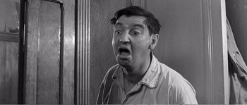 Movie still from “The 400 Blows” (1959), directed by François Truffaut – An old photo of a man with a surprised look on his face; Close Up shot, Low angle
