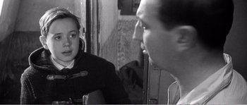 Movie still from “The 400 Blows” (1959), directed by François Truffaut – A man and a woman are talking in a room; Close Up shot, Over the shoulder angle