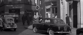 Movie still from “The 400 Blows” (1959), directed by François Truffaut – An old black and white photo of people walking on the sidewalk; Extreme Wide shot, High angle