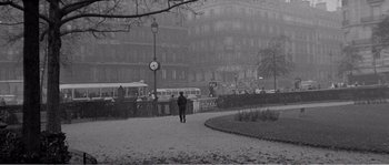 Movie still from “The 400 Blows” (1959), directed by François Truffaut – A person walking on a sidewalk near a building; Extreme Wide shot, High angle