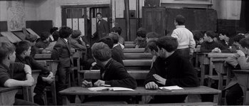 Movie still from “The 400 Blows” (1959), directed by François Truffaut – Black and white photograph of people sitting at benches; Wide shot, High angle