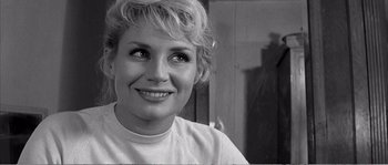 Movie still from “The 400 Blows” (1959), directed by François Truffaut – Black and white photograph of a woman smiling for the camera; Close Up shot, Over the shoulder angle