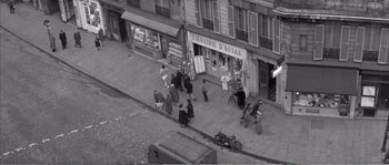 Movie still from “The 400 Blows” (1959), directed by François Truffaut – A black and white photo of people walking down a street; Extreme Wide shot, High angle