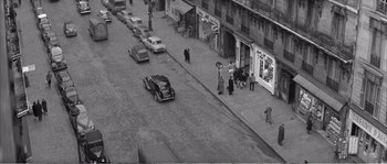 Movie still from “The 400 Blows” (1959), directed by François Truffaut – An old black and white photo of people walking on a street; Extreme Wide shot, High angle