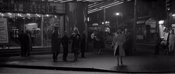 Movie still from “The 400 Blows” (1959), directed by François Truffaut – A black and white photo of people walking on the sidewalk; Extreme Wide shot, High angle