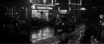 Movie still from “The 400 Blows” (1959), directed by François Truffaut – A black - and - white photo of cars parked on the side of the street; Extreme Wide shot, High angle