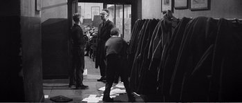 Movie still from “The 400 Blows” (1959), directed by François Truffaut – A group of people standing around a building; Wide shot, Low angle