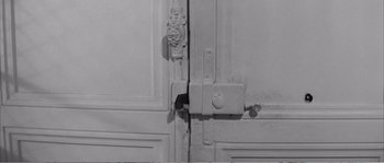 Movie still from “The 400 Blows” (1959), directed by François Truffaut – A black and white photo of a door lock; Extreme Close Up shot, High angle
