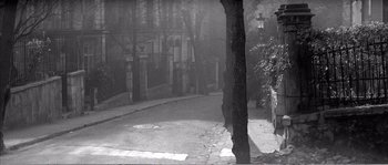 Movie still from “The 400 Blows” (1959), directed by François Truffaut – A black - and - white photo of a street corner; Extreme Wide shot, High angle