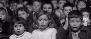 Movie still from “The 400 Blows” (1959), directed by François Truffaut – Black and white photograph of a young girl in a crowd; Close Up shot, High angle