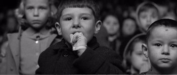Movie still from “The 400 Blows” (1959), directed by François Truffaut – Black and white photograph of a young boy in a crowd; Close Up shot, High angle