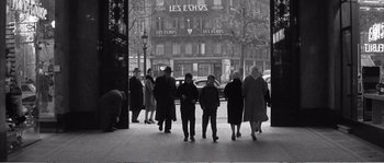 Movie still from “The 400 Blows” (1959), directed by François Truffaut – A black and white photo of a group of people walking down a sidewalk; Wide shot, High angle