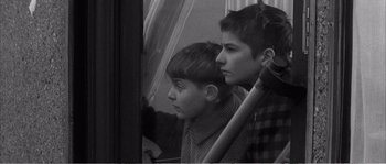 Movie still from “The 400 Blows” (1959), directed by François Truffaut – Two young boys looking out the window of a train; Medium shot, High angle