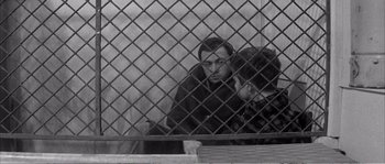 Movie still from “The 400 Blows” (1959), directed by François Truffaut – A man and a woman leaning against a metal fence; Medium shot, Over the shoulder angle