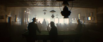 Movie still from “The Assassination of Jesse James by the Coward Robert Ford” (2007), directed by Andrew Dominik – A group of people standing in front of a building; Wide shot, Low angle