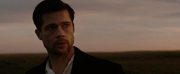 Movie still from “The Assassination of Jesse James by the Coward Robert Ford” (2007), directed by Andrew Dominik – A person wearing a suit and tie; Close Up shot, Over the shoulder angle